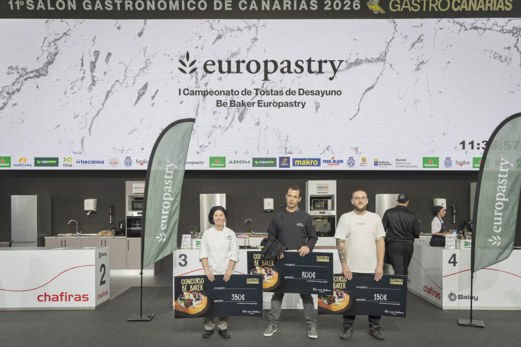 Contestants stand on a judging stage holding large prize boards at a Gastro Canarias event, with a Europastry banner and sponsor logos above them.
